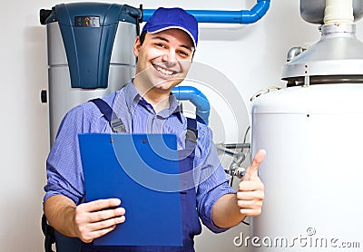 Technician servicing an hot-water heater Stock Photo