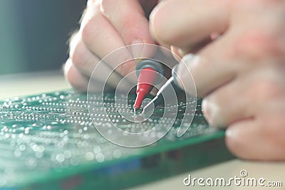 Engineer test electronic component on the circuit board Stock Photo