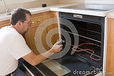 Technician testing stove & oven Stock Photo