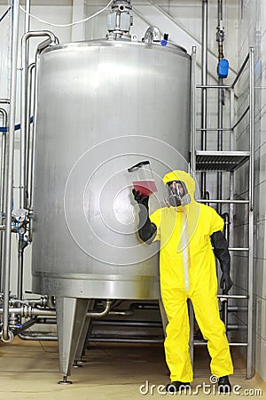 Technician in unoform examining sample of liquid Stock Photo