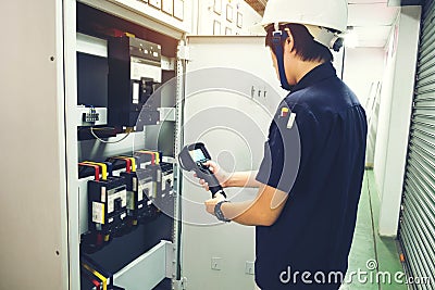 Technician use thermal imaging camera to check temperature in fa Stock Photo