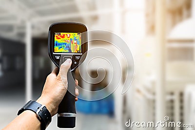 technician use thermal imaging camera to check temperature in fa Stock Photo