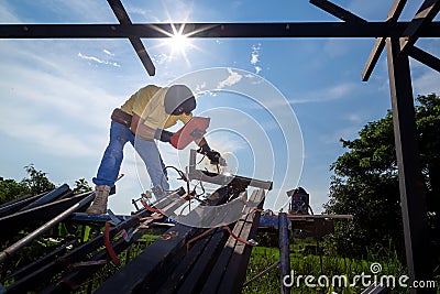 A technician uses a welding mask to work on a scaffold,Soft focus,selected focus,shallow depth of field Stock Photo