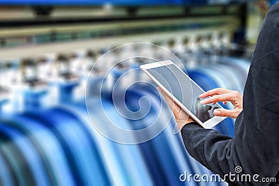 Technician using tablet control with format large inkjet printing blue vinyl Stock Photo