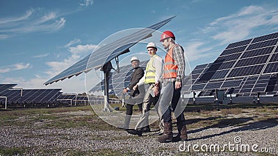 Technician walks with workman and investor Stock Photo