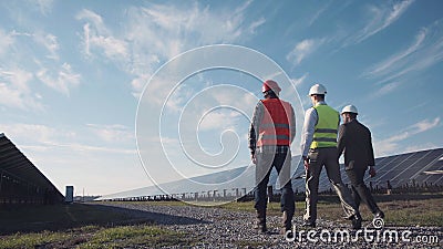 Technician walks with workman and investor Stock Photo