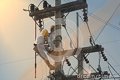 Technician work on high voltage electicity pole and reflect light Stock Photo