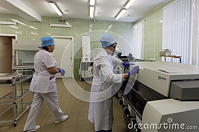 Technician works with analyzer in the blood bank Editorial Stock Photo