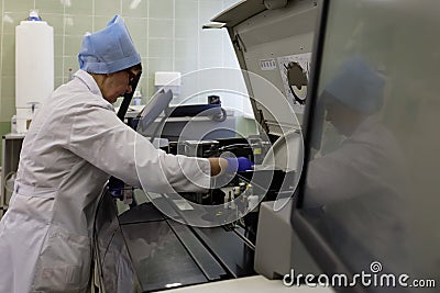 Technician works with analyzer in the blood bank Editorial Stock Photo