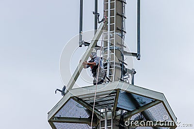 2 technicians carry out repairs on a radio mast Stock Photo
