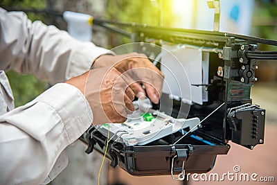 Technicians install cabinet on fiber optic cable. Stock Photo