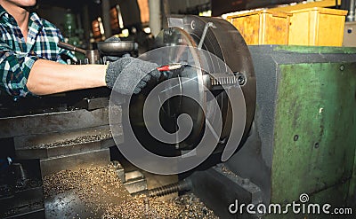 technicians man are working by controlling steel lathes, in parts production line Stock Photo