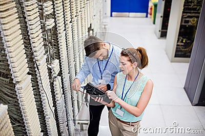 Technicians using digital cable analyzer Stock Photo