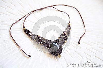 technique waxed string necklace with gemstone obsidian Stock Photo