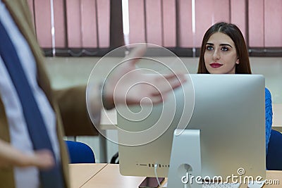 IT technologies teacher at work. IT professor explain lesson to multietchnic students. Professor`s hand with gesture Stock Photo