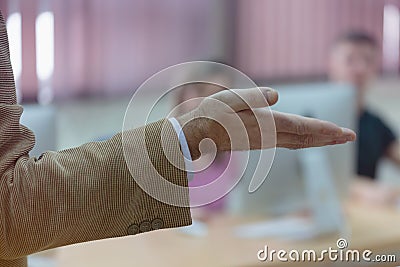 IT technologies teacher at work. IT professor explain lesson to multietchnic students. Professor`s hand with gesture Stock Photo