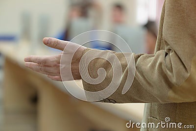 IT technologies teacher at work. IT professor explain lesson to multietchnic students. Professor`s hand with gesture Stock Photo