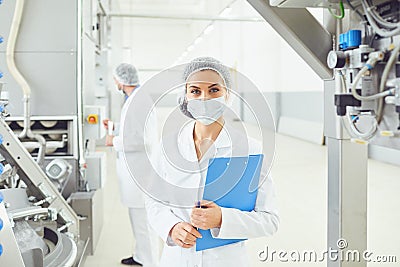 Technologist woman at food factory . Stock Photo