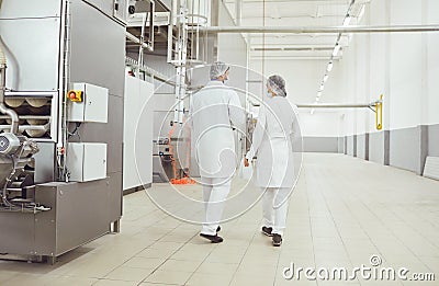 Technologists inspector in masks at food factory. Stock Photo
