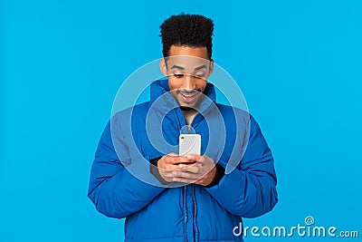Technology addication, mobile digital lifestyle concept. Amused and entertained african american guy smiling see girl Stock Photo