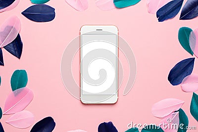 Technology background for mockup with Beautiful abstract pink green and blue feathers and smartphone. Desk for artist, painter. Stock Photo