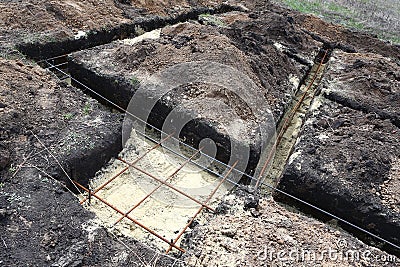 Technology of digging tranches under the pile and tape base fun Stock Photo
