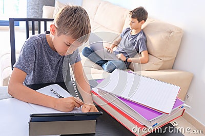 Technology, education, online learning, distance learning at home. Boy start doing mathematics homework with books and Stock Photo