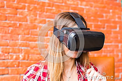 Technology, gaming, entertainment and people concept - young woman with virtual reality headset, controller gamepad Stock Photo