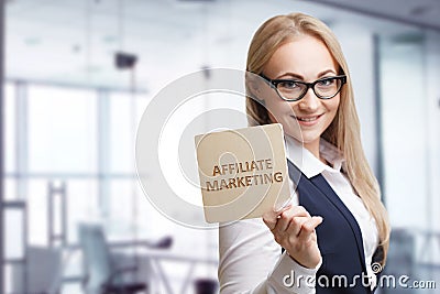 Technology, internet, business and marketing. Young business woman writing word: Affiliate marketing Stock Photo