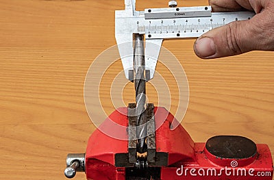 The technology of measuring the diameter of the drill, using calipers Stock Photo