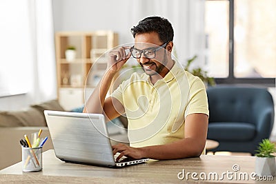 Indian man with laptop working at home office Stock Photo