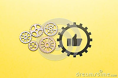 Technology for a set of likes and approvals in social networks. Icon thumbs up with gears. Stock Photo