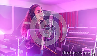 Technology, singing or woman on neon studio microphone, music lyrics or songwriting app in night recording. Singer Stock Photo
