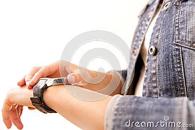 Technology, time, fast life. Woman in denim jacket looking at her wrist watch Stock Photo