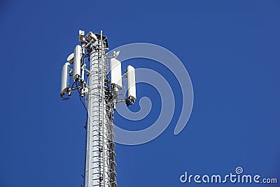Technology on the top of the telecommunication GSM 4G tower antenna, transmitter , blue sky, white clouds. Stock Photo