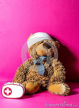 Teddy bear with bandage and first aid for mishap concept Stock Photo