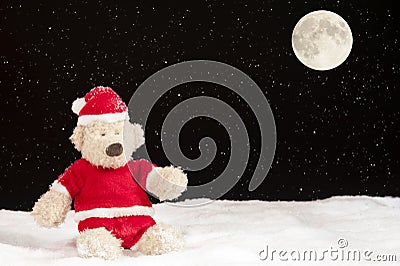 Teddy bear in christmas clothes in the snow Stock Photo