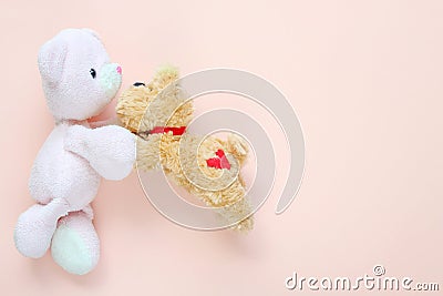 Teddy bear and cute puppy doll hugging on a pink background. Stock Photo