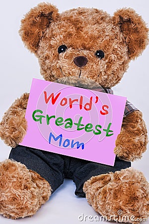 Teddy bear holding pink sign saying World`s Greatest Mom Stock Photo