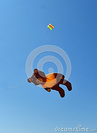 Teddy Bear Kite in Flight against Blue Sky Stock Photo