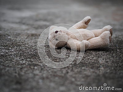 Teddy bear is laying down on the floor. lonely concept. internat Stock Photo