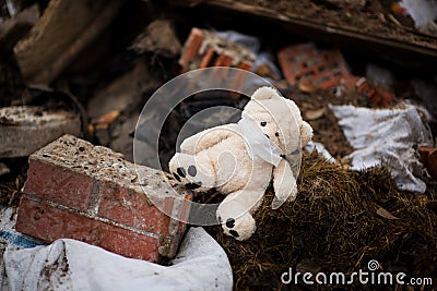 Teddy bear in a medical mask lies in the trash Stock Photo