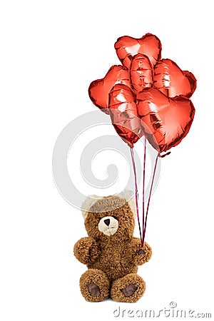Teddy bear with red heart shaped balloons. Stock Photo