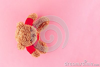 Teddy bear in red shirt isolated on pink background, mock up for card celebration. Top view. Stock Photo