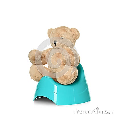 Teddy bear sitting on blue potty. Toilet training Stock Photo