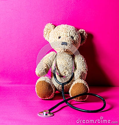 Teddy bear with stethoscope for checking an injury after mishap Stock Photo