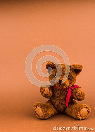 Teddy bear toy on a brown background with copy space Stock Photo