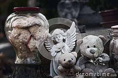 Teddy bears, angel and other toys on baby grave in the cemetery. Ð¡lose-up. concept: death, loss Stock Photo