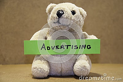 Teddybear holding advertising. Stock Photo