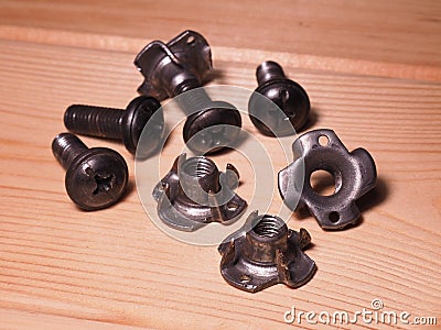 Tee nuts four pronged captive blind threaded inserts for wood furniture Stock Photo